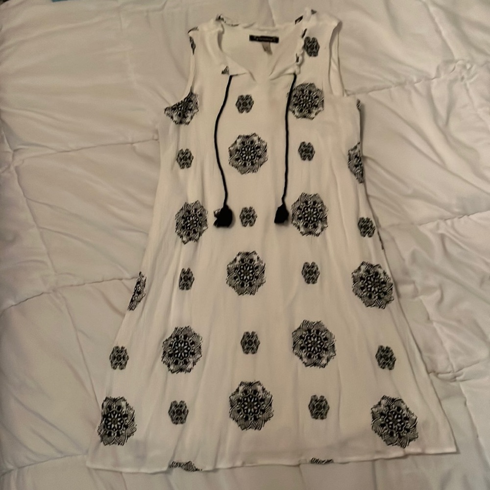Super cute and tight fiting white dress with black designs!